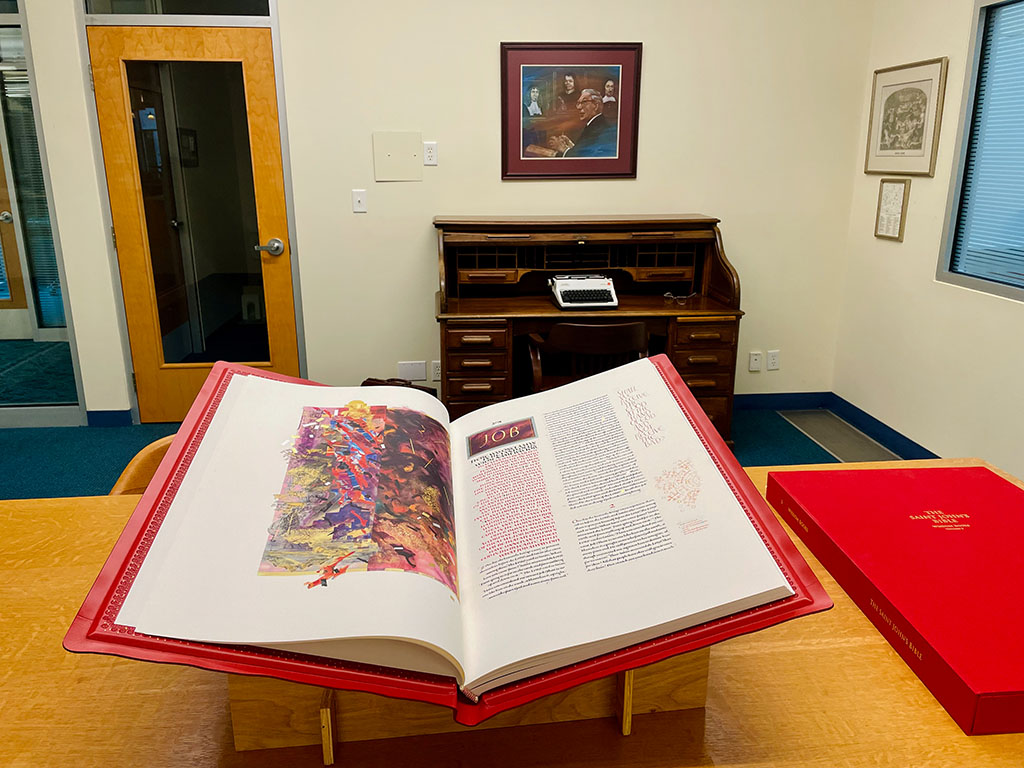 An open volume of the The Saint John's Bible on the table in the Reading Room